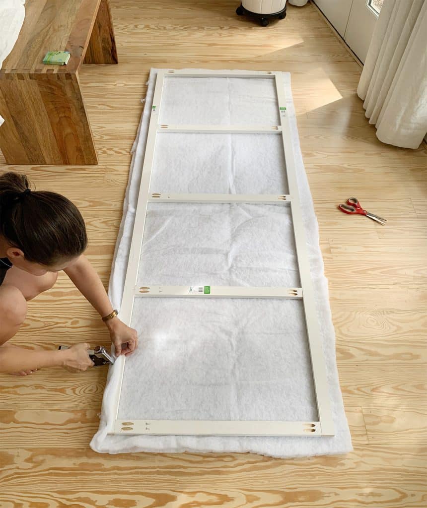 headboard-diy-sherry-making-larger-frame-860x1024-1 Sherry stapling two layers of batting to second larger wood frame for DIY headboard