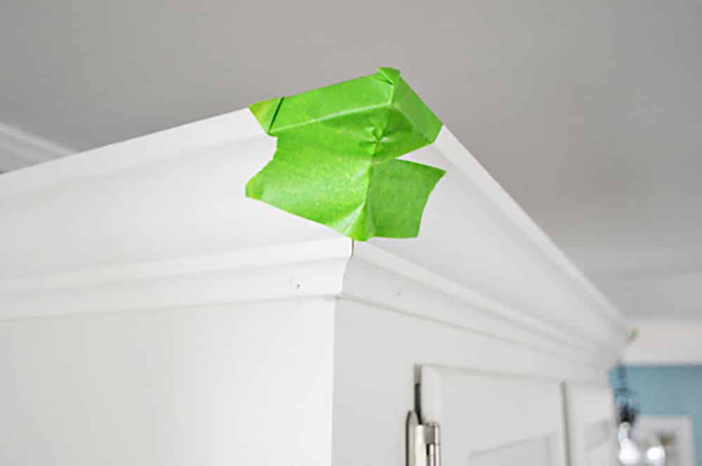 kitchen-crown-outside-corner-taped Green painters tape on the corner of kitchen crown molding while glue dries