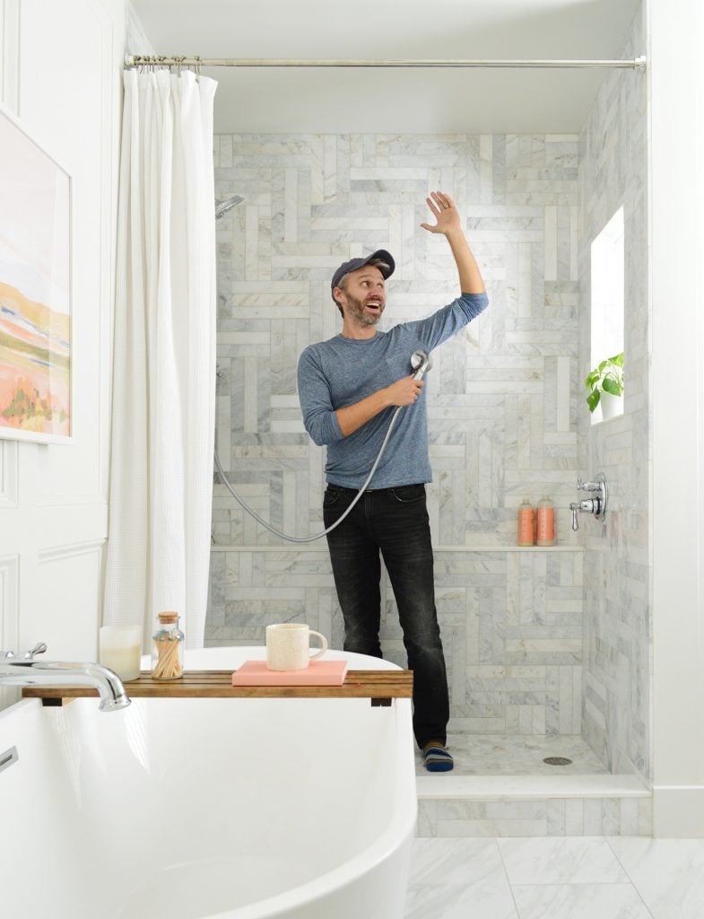 marble-master-bathroom-john-in-shower-785x1024-1 John standing in marble tiled shower pretending to shower