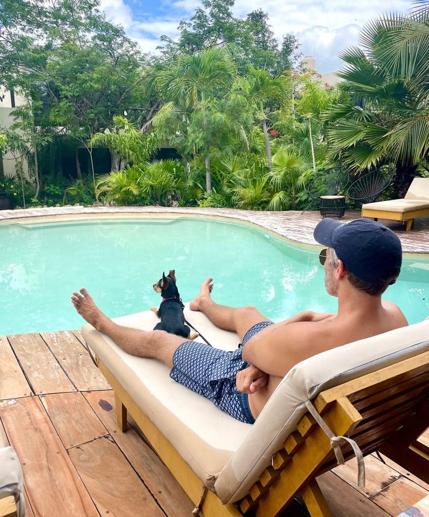 mexico-with-kids-john-penny-at-pool-850x1024-1 John Sitting By Pool In Akumal With Penny The Dog