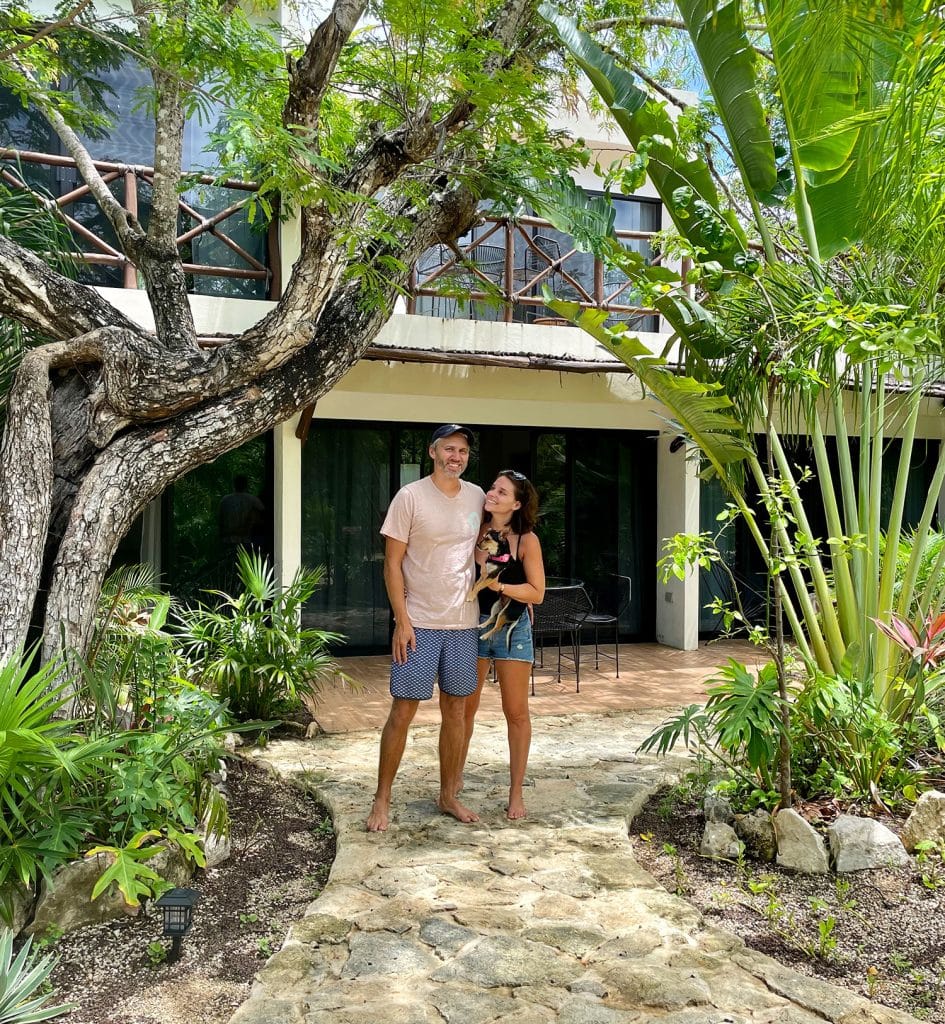 mexico-with-kids-john-sherry-in-front-of-airbnb-945x1024-1 John And Sherry Standing At Arkah Airbnb in Akumal Mexico