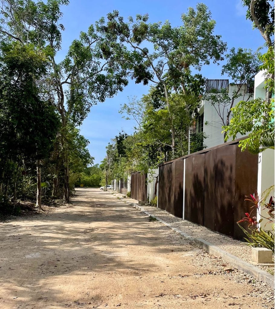 mexico-with-kids-tulum-airbnb-gate-910x1024-1 Unpaved Street With Gated Homes In La Veleta Tulum Mexico