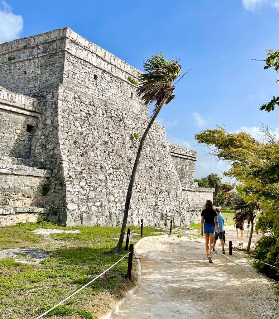 mexico-with-kids-tulum-ruins-castillo-895x1024-1 Kids Walking In Front of Castillo At Tulum Ruins Mexico