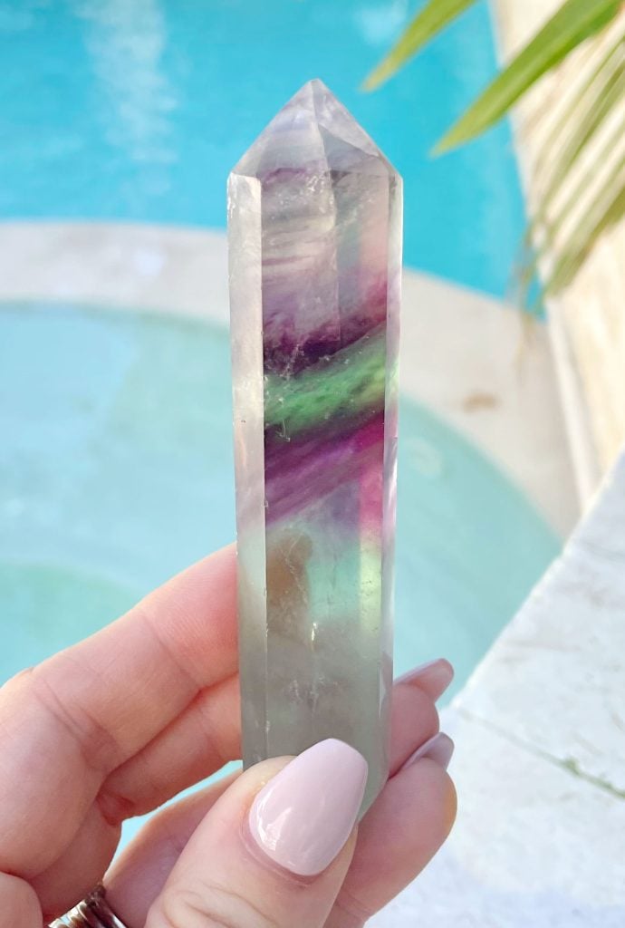 rainbow-fluorite-point-by-water-690x1024-1 Rainbow Fluorite Crystal Point In Hand By Pool