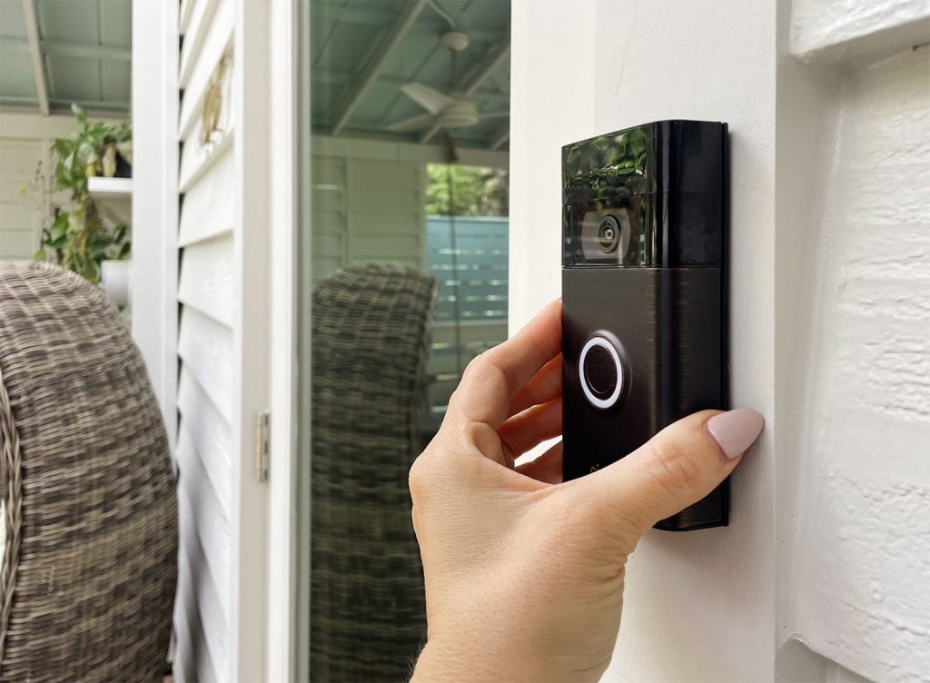 ring-video-doorbell-hang-placing-1024x752-2 Hand Placing Ring Video Doorbell Onto Mount