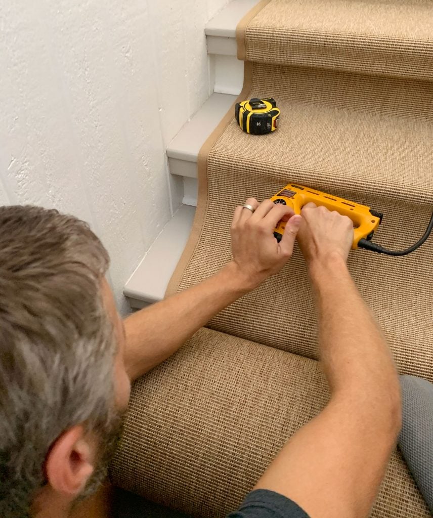 sisal-stair-runner-putting-pressure-on-back-of-stapler-856x1024-1 John Stapling Sisal Runner Under Lip of Stair Tread