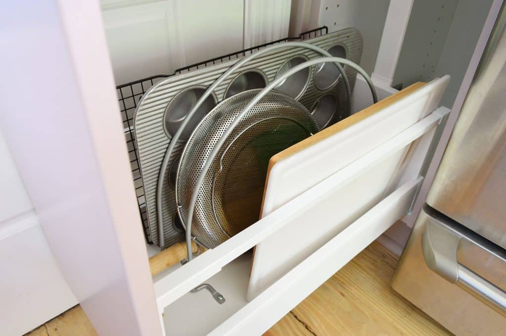 small-kitchen-org-stove-cabinet-detail-1024x681-1 Detail Of Metal Dividers Separating Cutting Boards And Muffin Tins