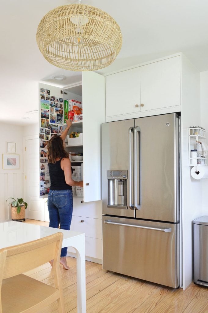 small-kitchen-pantry-sherry-reaching-681x1024-1 Sherry Standing In Front Of Open Ikea Pantry Cabinets Built To Ceiling