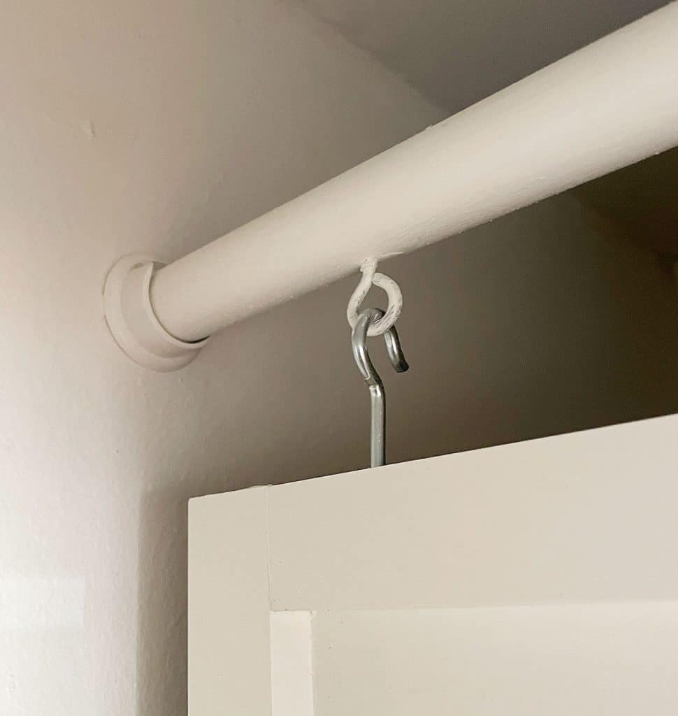 utility-closet-hook-in-closet-rod-970x1024-1 Eye Hook Suspending Wood Panel From Closet Rod In Utility Closet