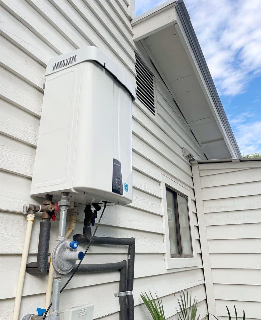 utility-closet-tankless-water-heater-837x1024-2 Tankless gas water heater on exterior of Florida home