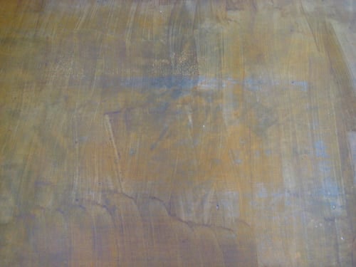 after-stain-gross failed attempt at staining a darker brown color on concrete floor over a yellow stain floor with streaky results