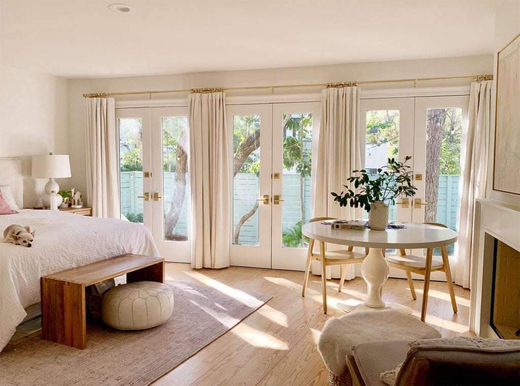 bedroom-wide-shot-of-doors-1024x760-2 Bedroom with three french doors with with curtains and sunlight coming in