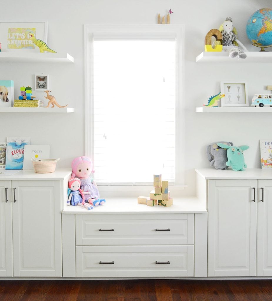 built-in-bonus-room-cabinets-shelves-window-925x1024-1 Built In Cabinets Under Window With Floating Shelves In Playroom