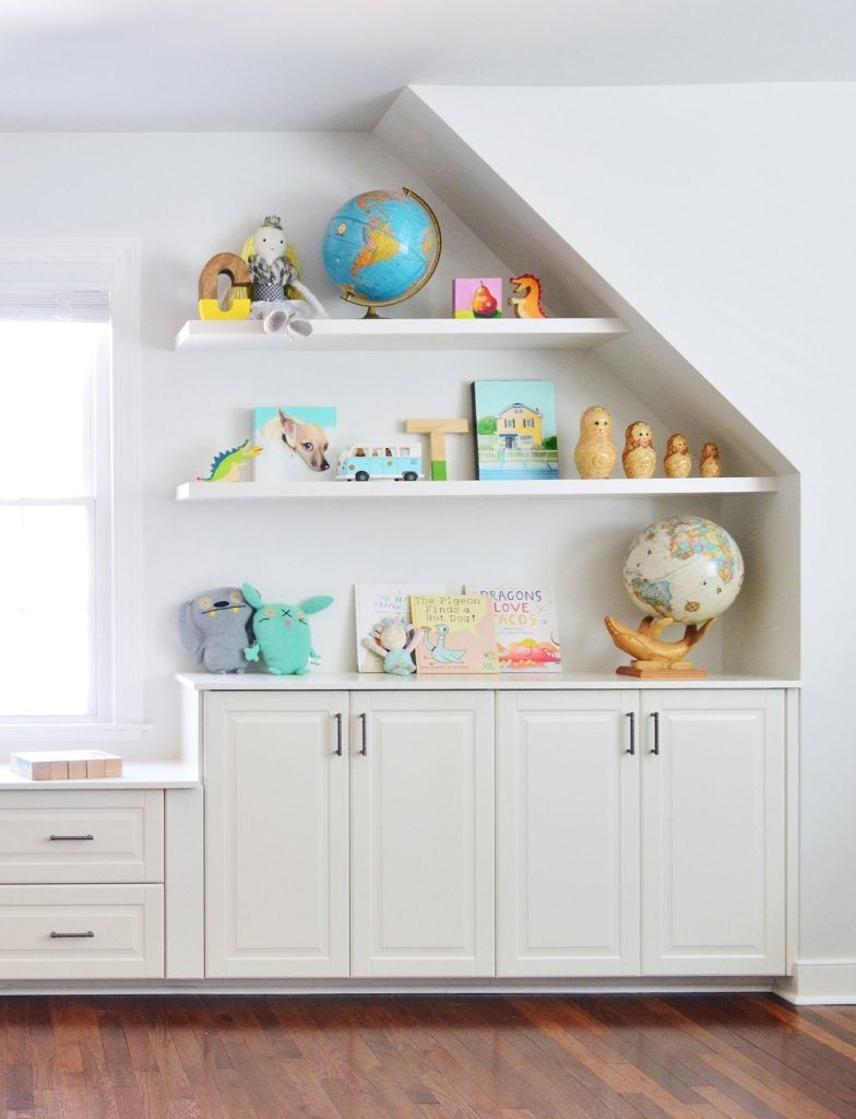built-in-bonus-room-shelves-right-side-784x1024-1 White Floating Shelves In Playroom With Toys Over Storage Cabinets