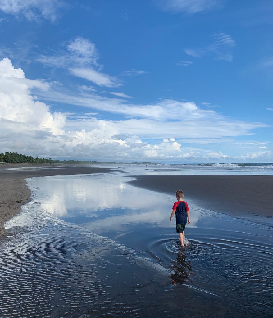 costa-rica-vacation-esterillos-oeste-beach-tidepools-walking-879x1024-1 Young Boy Playing In Tide Pool at Esterillos Oeste Beach In Costa Rica