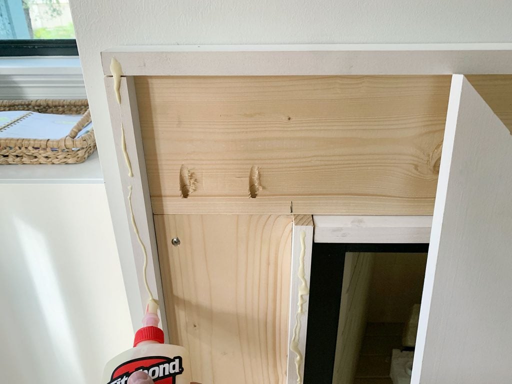 diy-fireplace-mantel-adding-glue-1024x768-1 Wood Glue Squeezed Onto Brace Piece To Help Secure Face Pieces