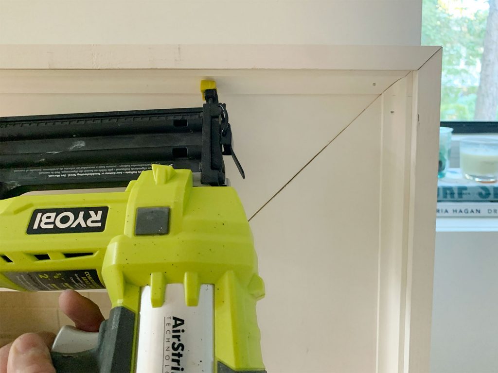 diy-fireplace-mantel-nailing-cove-1024x768-1 Nail Gun Securing Small Corner Trim Piece Along Inside Edge Of Mantel