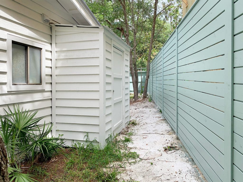 ep181-fence-with-shed-1024x768-1 Small white shed attached to side of white house