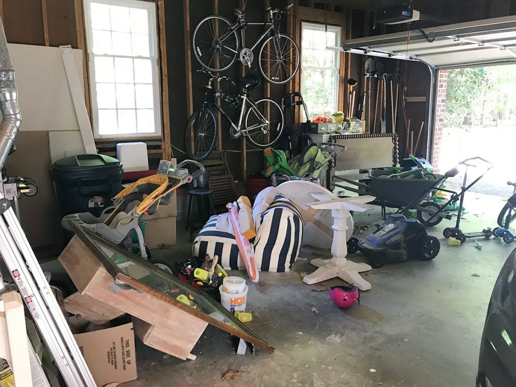 ep97-garage-before-from-door-1024x768-1 Messy garage with bikes and spare furniture