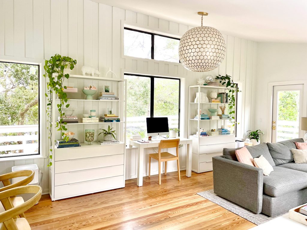 family-room-bookshelf-wall-wide-1024x768-1 After Photo Of Modern Upstairs Family Room With White Paneled Walls And Capiz Globe Light Fixture