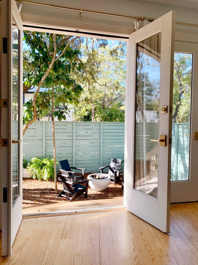 firepit-area-through-bedroom-doors-768x1024-1 View of fire pit area through open french doors in bedroom