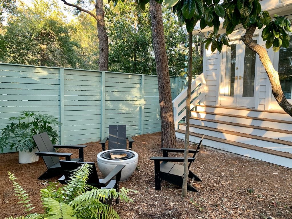 firepit-area-wide-shot-angled-towards-house-1024x768-2 Blue-green painted horizontal fence around side yard with long steps leading up to bedroom