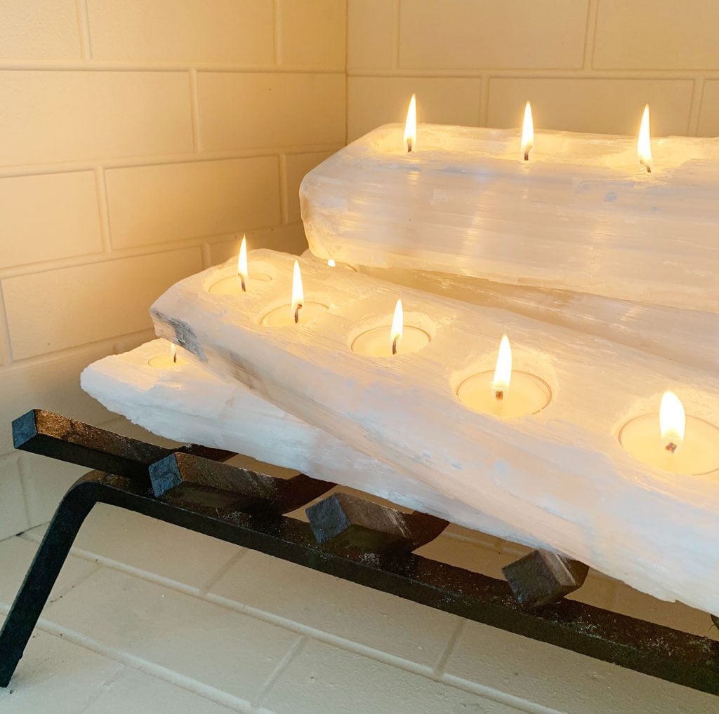 florida-bedroom-fireplace-crystal-detail-lit-1024x1018-1 Close-up of tealight holder crystal logs with candles lit