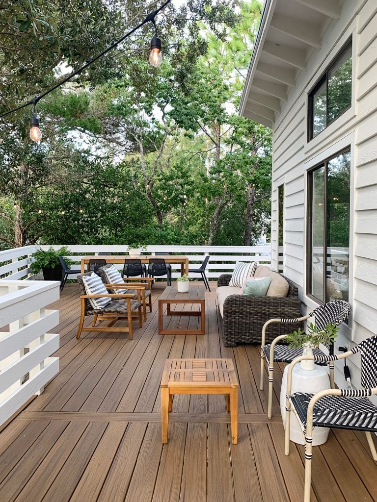 florida-deck-full-from-corner-vertical-straight-768x1024-1 Second Floor Deck With Various Seating Areas Surrounded By Trees