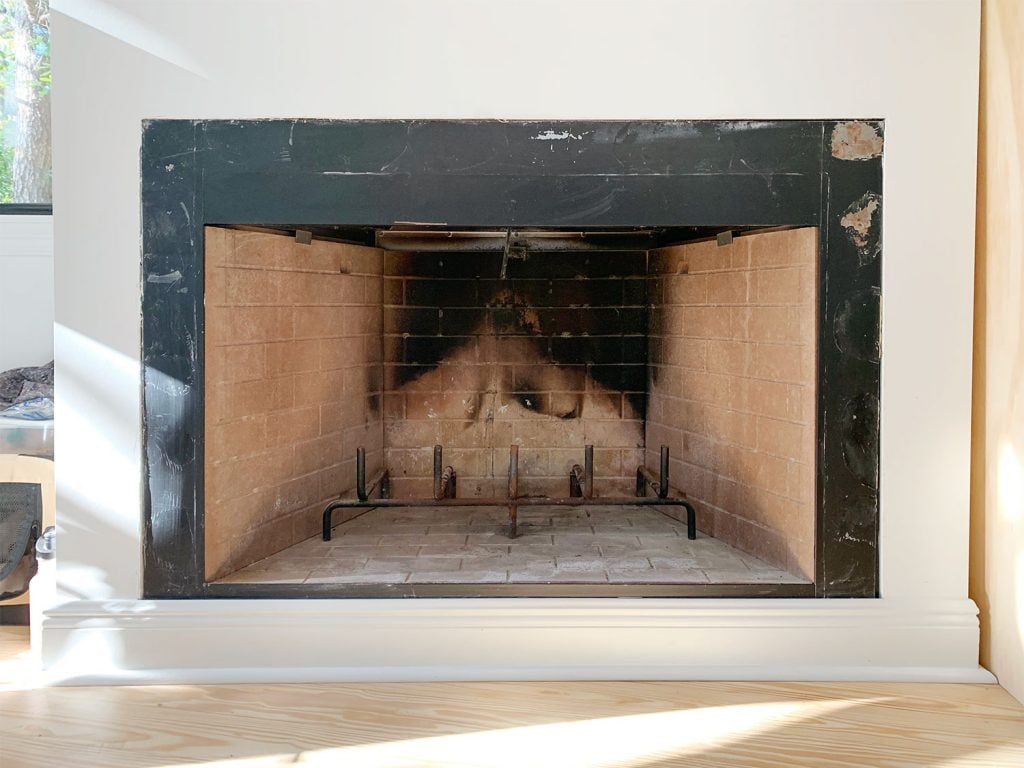 florida-fireplace-scraped-clean-1024x768-1 Before photo of fireplace with charred brick interior and patchy black metal surround