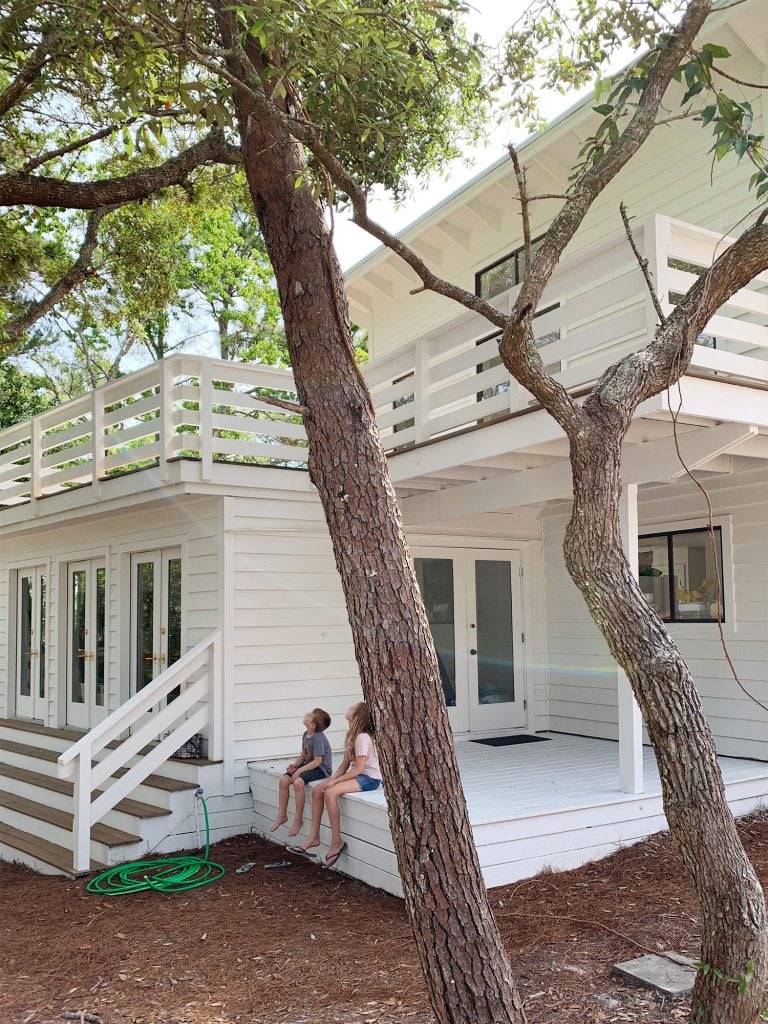 florida-house-exterior-after-may-kids-on-bedroom-porch-768x1024-1 Covered white porch on move-in day with kids sitting on stoop