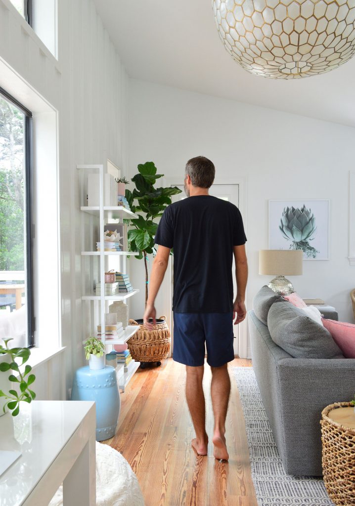 florida-living-room-to-door-with-john-718x1024-1 Man In Black Shirt Walking In Living Room Under Large Light Fixture