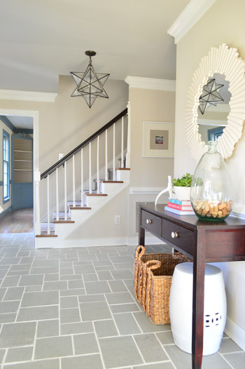 grout11 foyer entryway with gray slate tile floor and clean white grout lines including pretty mirror and star pendant light