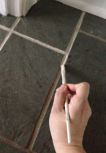 grout4 applying Oyster Gray PolyBlend Grout Renew to dirty tile grout lines with paintbrush