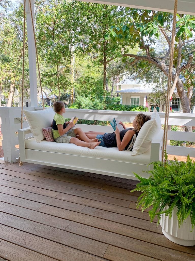 hanging-daybed-kids-on-it-wide-shot-768x1024-2 Two Kids Reading On Either End Of White Hanging Daybed Swing