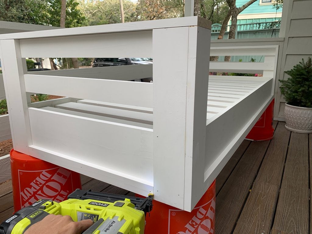 hanging-daybed-nailing-bottom-trim-1024x768-1 Nailing 1x2 trim piece along the bottom edge of hanging daybed