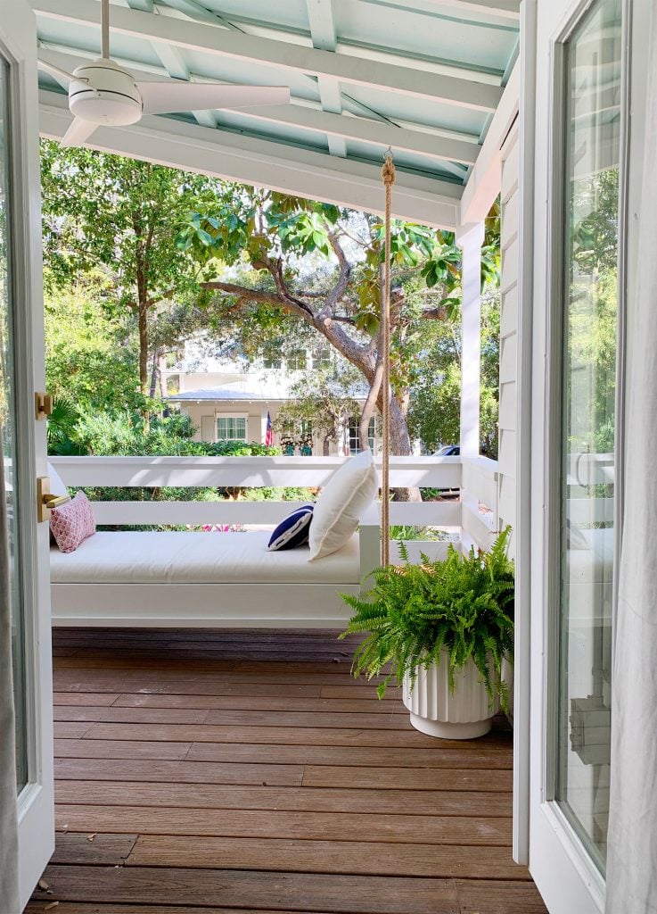 hanging-daybed-vertical-through-french-door-737x1024-1 View Of White Hanging Daybed Swing Under Covered Porch Through Open French Doors