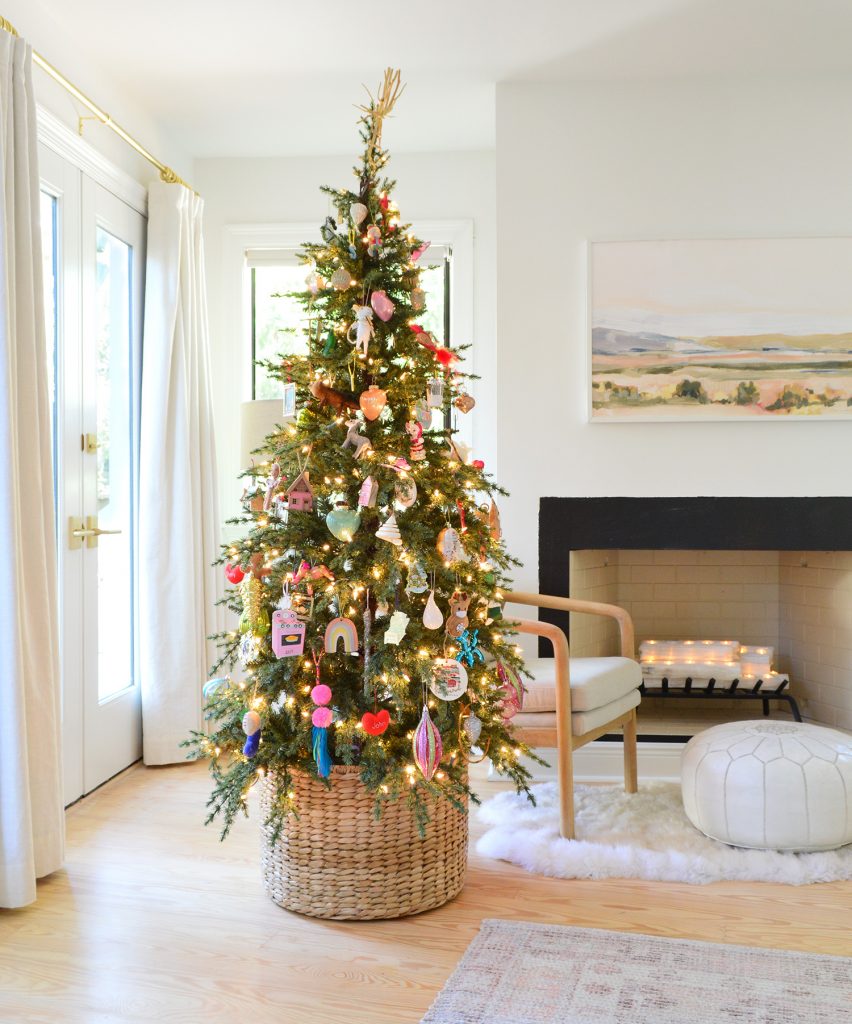 holiday-decor-2020-christmas-tree-in-basket-profile-852x1024-1 Woven Basket At Base Of Christmas Tree With Colorful Ornaments