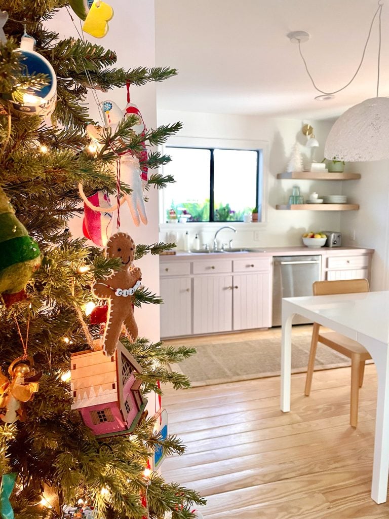 holiday-house-corner-of-tree-looking-into-kitchen-768x1024-1 Side of Christmas tree near pantry in kitchen