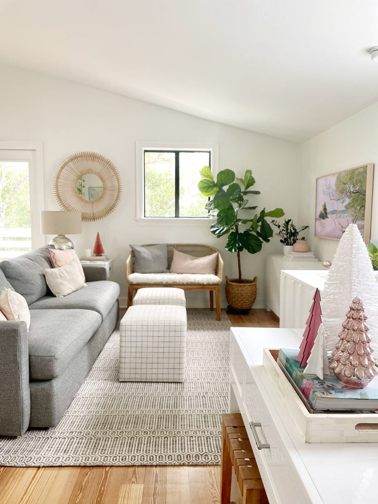 holiday-house-family-room-straight-on-768x1024-1 Wide view of living room with new sheepskin loveseat and decorative Christmas trees on tabletop