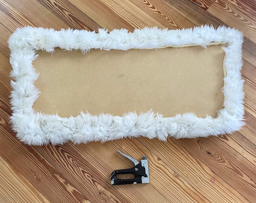 holiday-house-seat-reupholstered-1024x815-1 Backside of loveseat seat upholstered with sheepskin rug