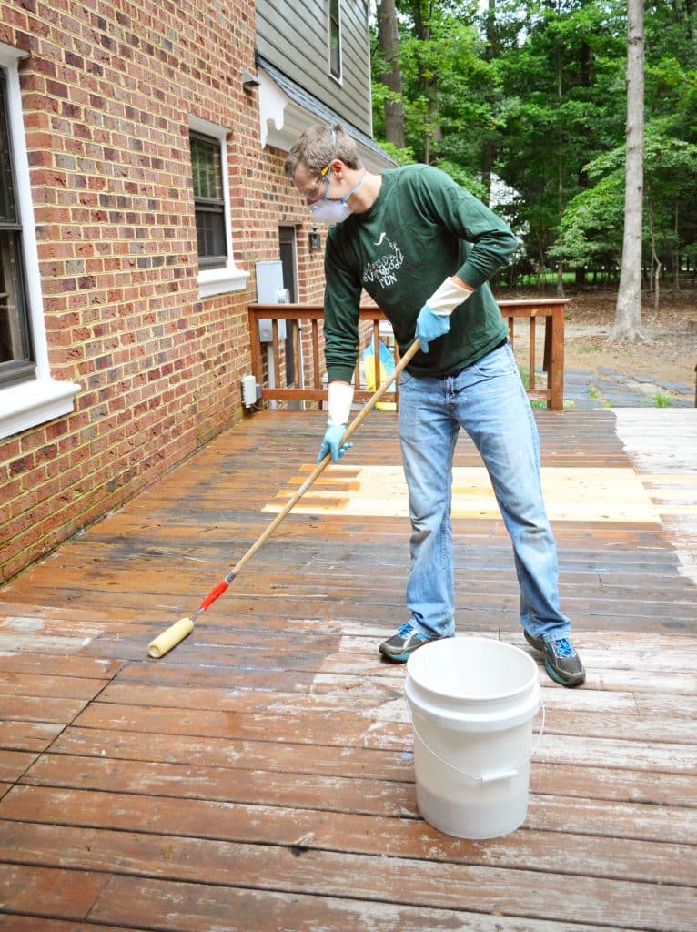 how-to-strip-a-deck-john-rolling-on-766x1024-1 John rolling stripper on deck using a paint roller pole