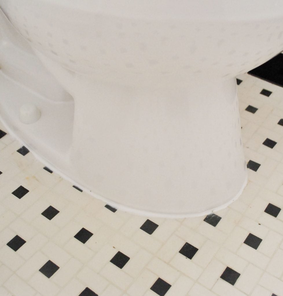 install-a-toilet-caulk-978x1024-1 Line Of White Caulk Around Base Of Installed Toilet