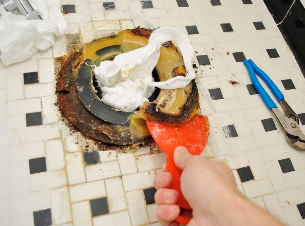 install-a-toilet-remove-wax-ring-1024x760-1 Scraping Old Wax Ring From Bathroom Floor During Toilet Installation