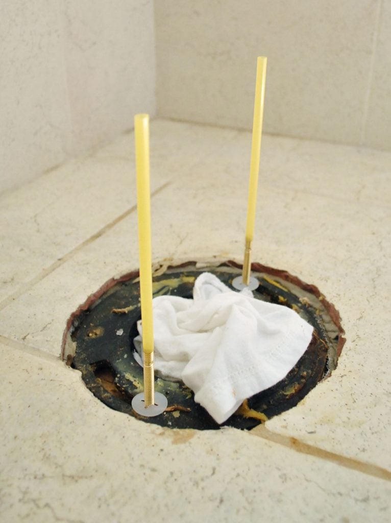 install-a-toilet-straws-over-bolts-766x1024-1 Straw Trick On Toilet Flange Bolts