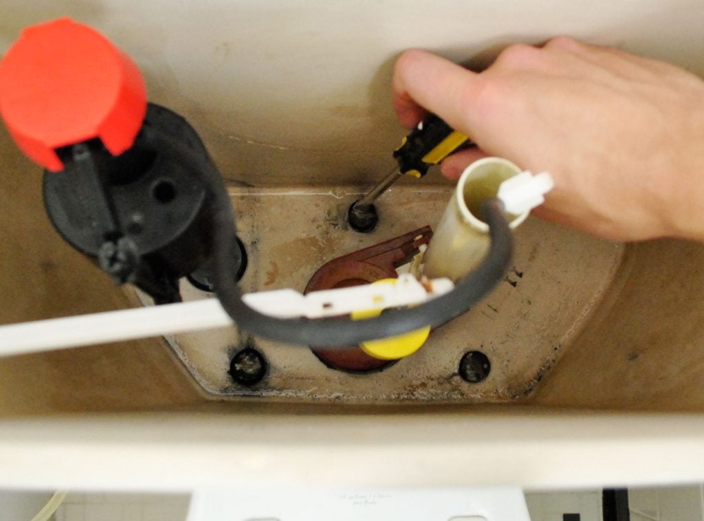 install-a-toilet-tightening-tank-bolts-1024x758-1 Hand Unscrewing Bolts Inside Toilet Tank