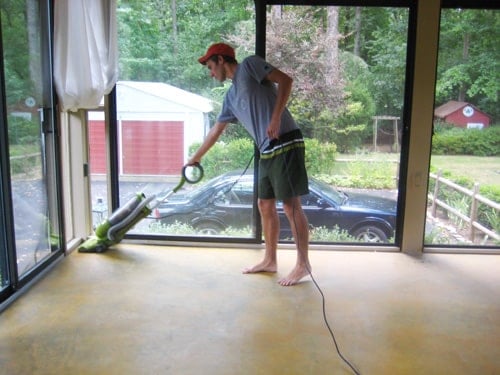 john-vacuums-for-prep cleaning concrete floor in glass doored sunroom prior to DIY stain application using a vacuum