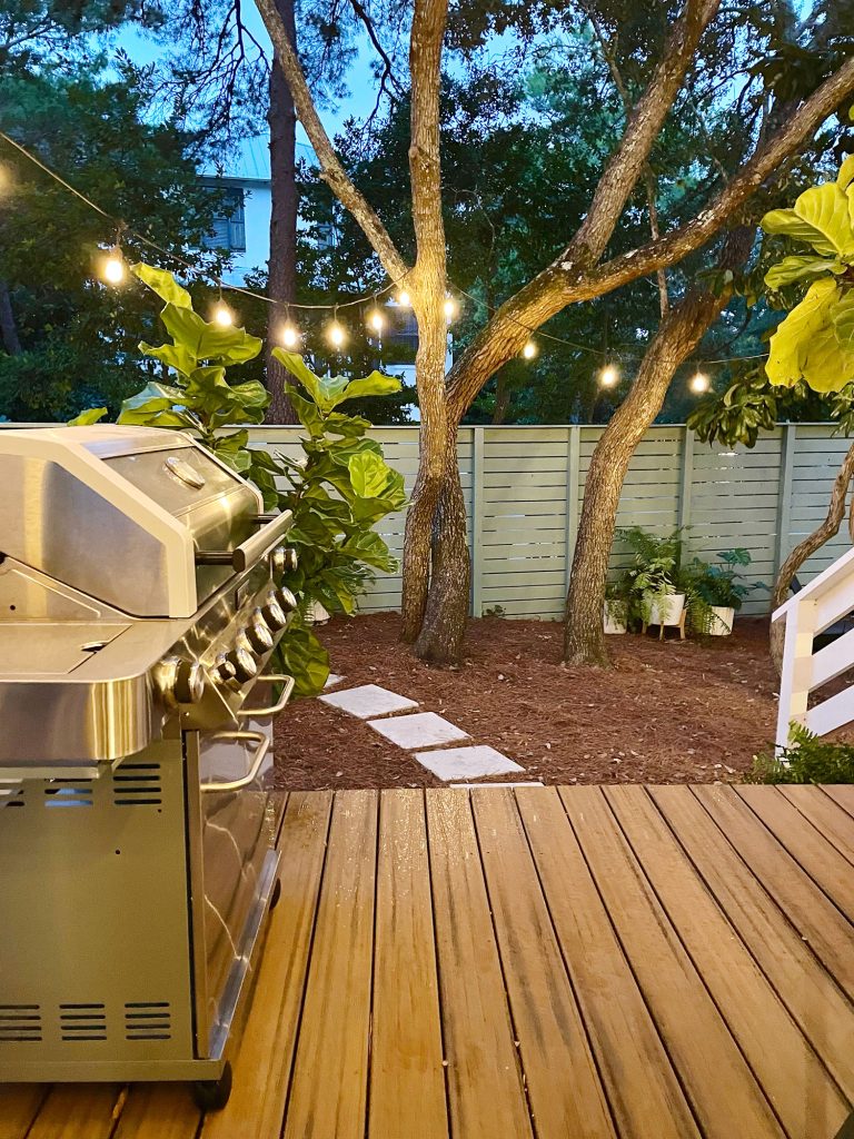 kitchen-porch-after-looking-out-at-night-768x1024-1 Night view from porch with string lights glowing in side yard