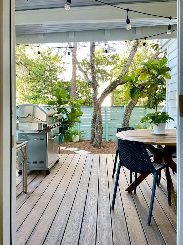 kitchen-porch-through-open-door-vertical-768x1024-1 View through kitchen door of covered kitchen porch with table and grill