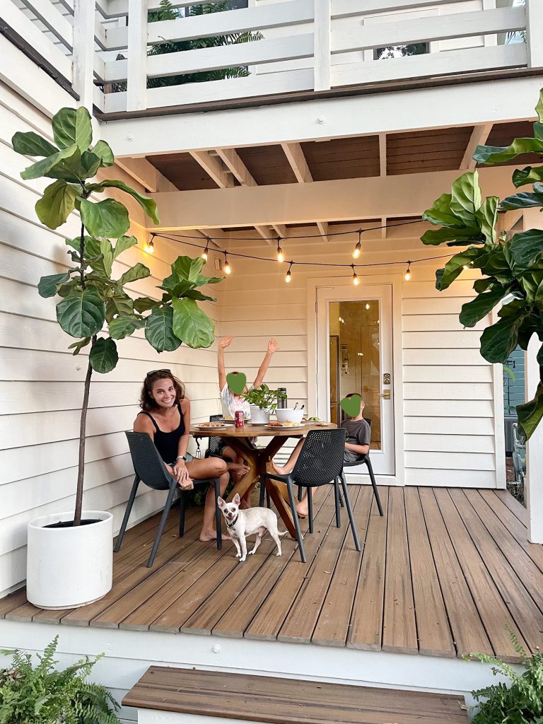 kitchen-porch-wide-768x1024-1 Family eating outside on covered porch with string lights on and chihuahua under table