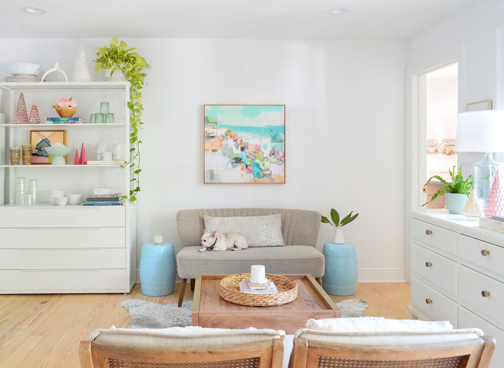kitchen-seating-area-full-with-burger-final-1024x748-1 Seating area with settee against wall with painting above next to white metal shelf